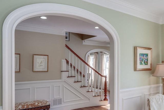 staircase featuring crown molding