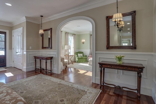 foyer with dark hardwood / wood-style flooring and ornamental molding