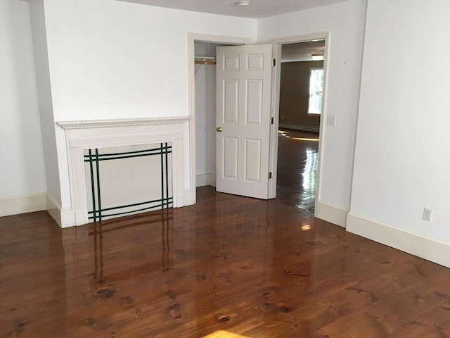 697 Main St, Shrewsbury, MA 01545 - unfurnished room featuring wood finished floors, a baseboard heating unit, and baseboards