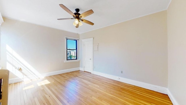 empty room featuring ceiling fan and light hardwood / wood-style floors