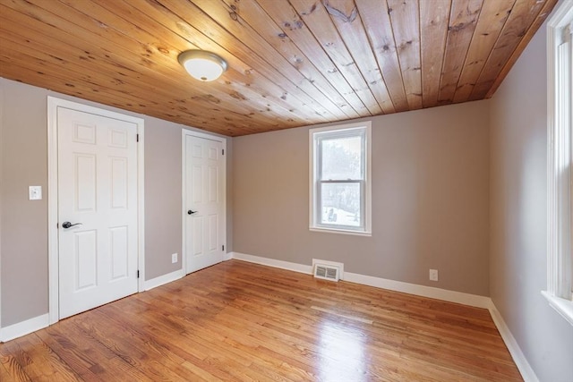 additional living space featuring light hardwood / wood-style floors and wooden ceiling