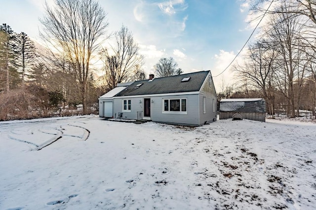 snow covered property with a storage shed