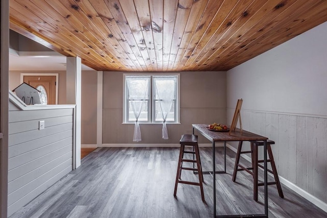 dining room featuring wood-type flooring and wood ceiling