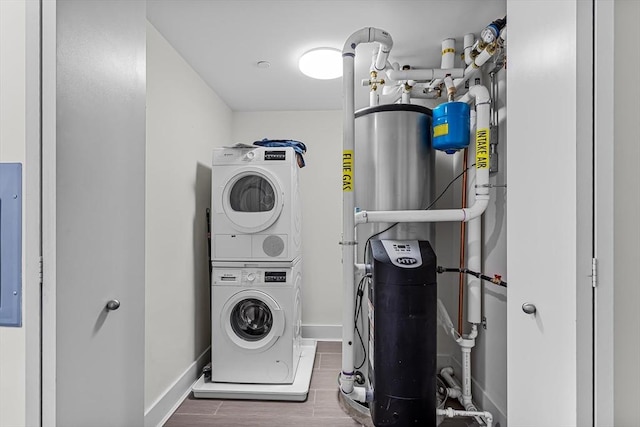 121 Portland St Unit 601, Boston, MA 02114 - laundry area with stacked washer / dryer, baseboards, and wood finished floors