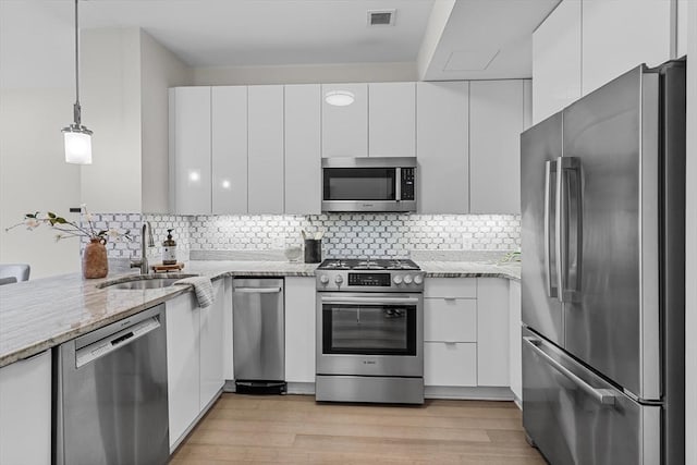 121 Portland St Unit 601, Boston, MA 02114 - kitchen with stainless steel appliances, modern cabinets, a sink, and white cabinets