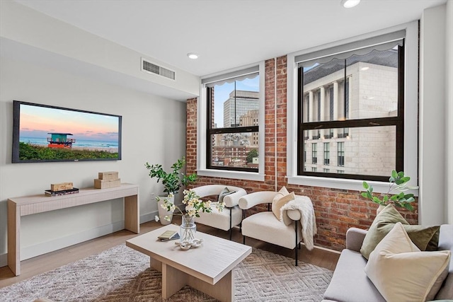 121 Portland St Unit 601, Boston, MA 02114 - living area with brick wall, wood finished floors, recessed lighting, and baseboards