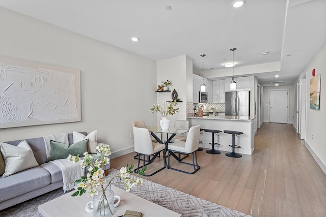 121 Portland St Unit 601, Boston, MA 02114 - living area with light wood-style floors, baseboards, and recessed lighting
