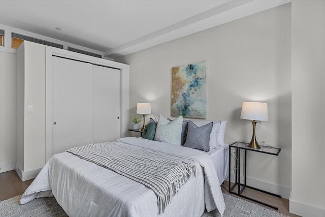 121 Portland St Unit 601, Boston, MA 02114 - bedroom featuring a closet, wood finished floors, and baseboards