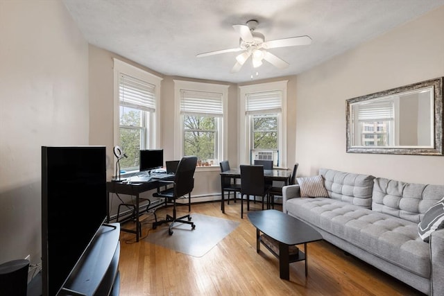 home office with a ceiling fan and wood finished floors