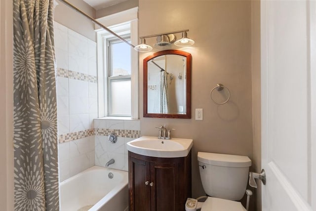 full bath featuring shower / tub combo with curtain, toilet, and vanity