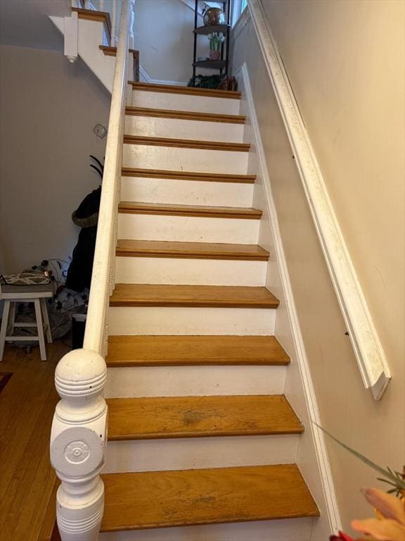 stairway featuring hardwood / wood-style flooring