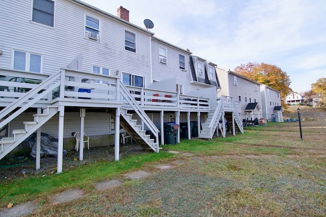 back of house featuring a wooden deck and cooling unit