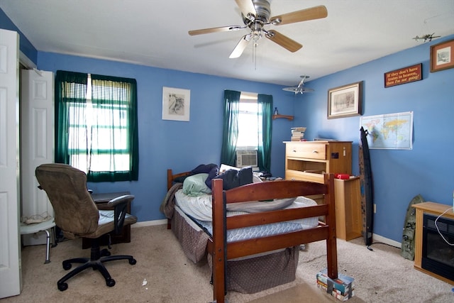 carpeted bedroom featuring cooling unit and ceiling fan