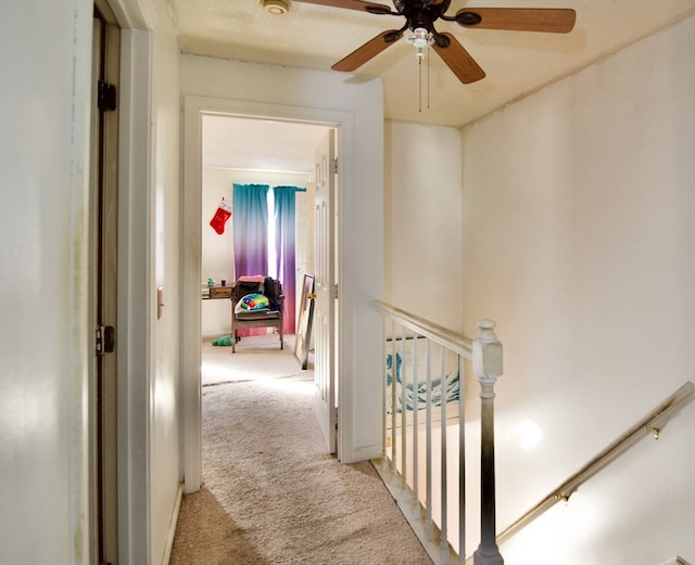 hall featuring light colored carpet