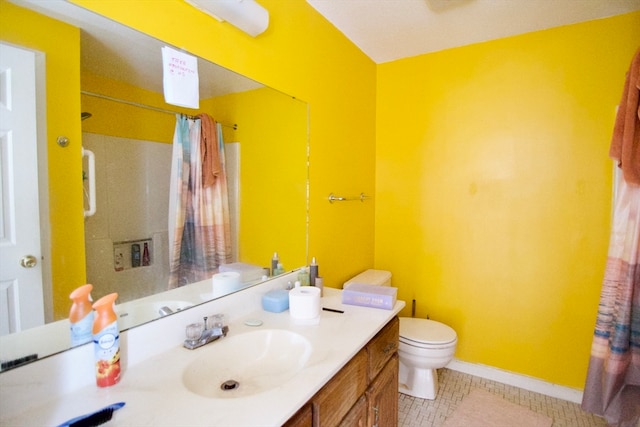 bathroom featuring toilet, vanity, tile patterned flooring, and walk in shower