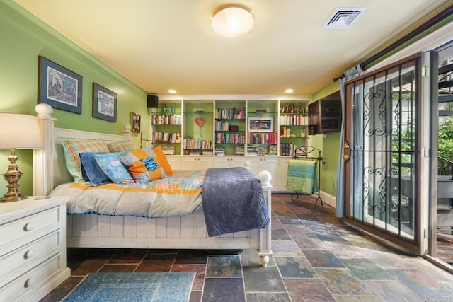 bedroom featuring access to outside, visible vents, and stone tile flooring