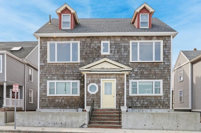 view of front of home with entry steps and roof with shingles