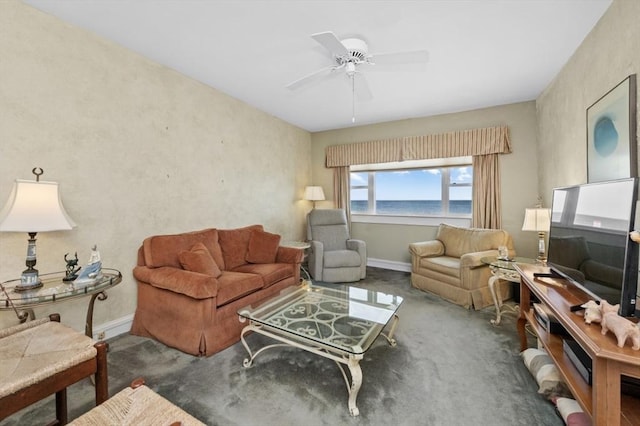 living room featuring baseboards, ceiling fan, and carpet flooring