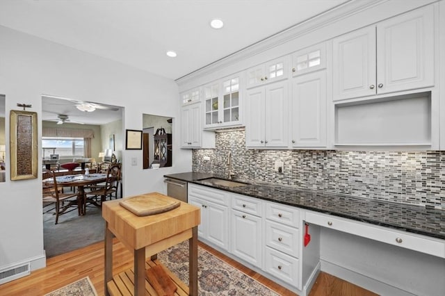 kitchen featuring a sink, visible vents, and white cabinets