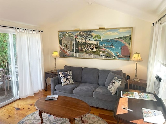 living room featuring hardwood / wood-style floors and vaulted ceiling