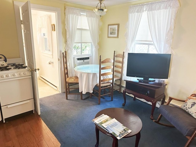 dining room featuring baseboard heating, dark hardwood / wood-style flooring, and cooling unit