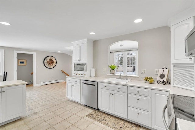 kitchen featuring dishwasher, range, white cabinets, a baseboard radiator, and sink