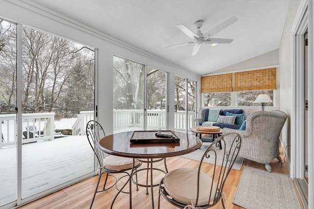 sunroom / solarium with ceiling fan and vaulted ceiling