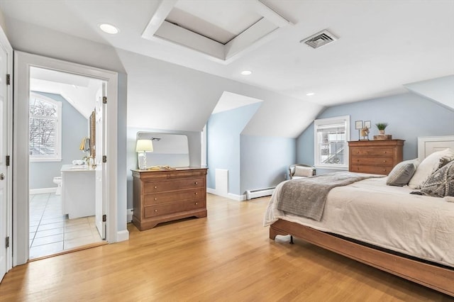 bedroom with light wood-type flooring, ensuite bath, lofted ceiling, and a baseboard heating unit