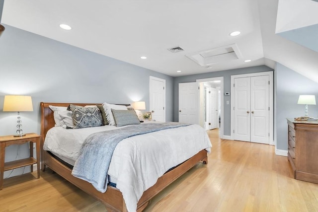 bedroom featuring lofted ceiling and light hardwood / wood-style floors