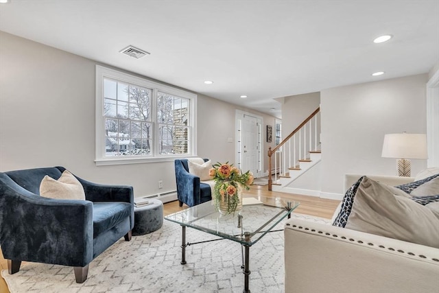 living room featuring light wood-type flooring and a baseboard radiator