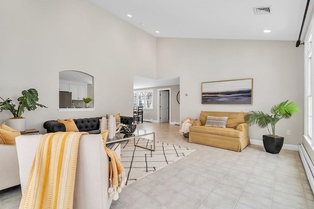 living room featuring a high ceiling and a baseboard radiator