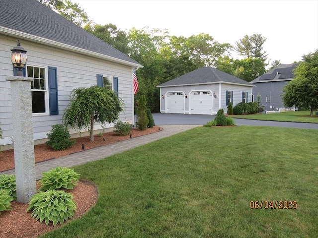 71 Frasier Ln, Tewksbury, MA 01876 - view of green lawn featuring a detached garage and an outbuilding