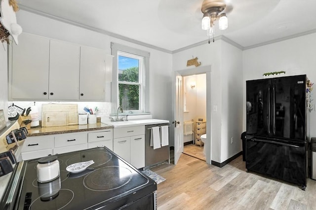 97 Newton St, Marlborough, MA 01752 - kitchen with black appliances, light wood finished floors, white cabinets, ceiling fan, and crown molding