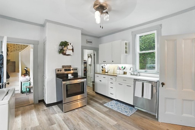 97 Newton St, Marlborough, MA 01752 - kitchen with stainless steel appliances, a ceiling fan, white cabinetry, washer / dryer, and light wood-style floors