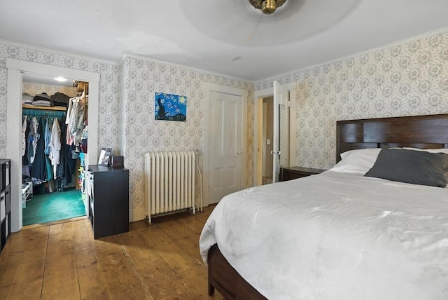 97 Newton St, Marlborough, MA 01752 - bedroom with radiator, hardwood / wood-style flooring, wallpapered walls, ornamental molding, and ceiling fan