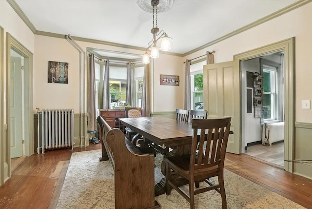 97 Newton St, Marlborough, MA 01752 - dining space featuring radiator heating unit, wood-type flooring, and ornamental molding