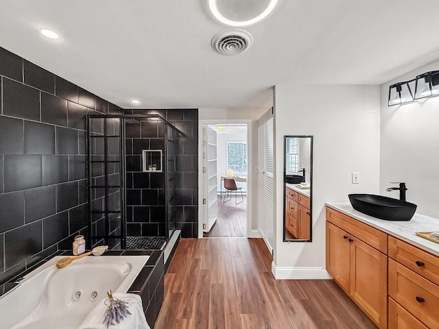 78 Howland Rd, Stoughton, MA 02072 - full bathroom with a shower stall, wood finished floors, vanity, a jetted tub, and baseboards