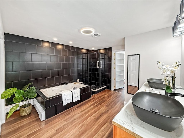 78 Howland Rd, Stoughton, MA 02072 - full bathroom with wood finished floors, a jetted tub, a stall shower, double vanity, and tile walls