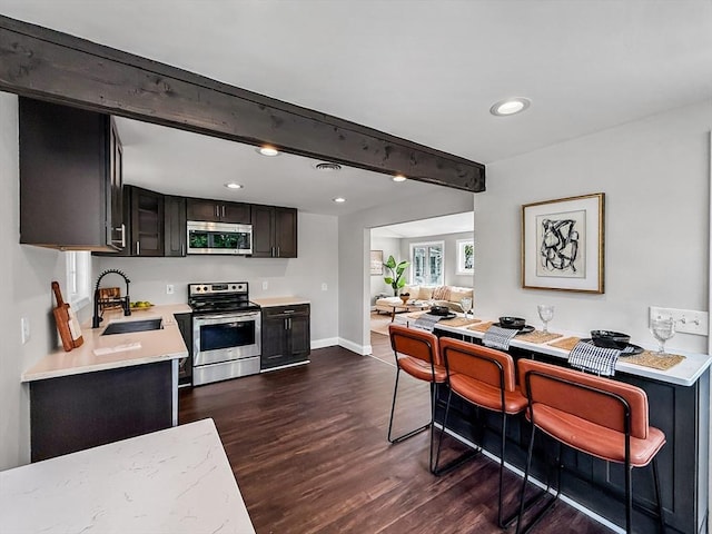 78 Howland Rd, Stoughton, MA 02072 - kitchen featuring stainless steel appliances, a sink, dark wood-style flooring, light countertops, and baseboards