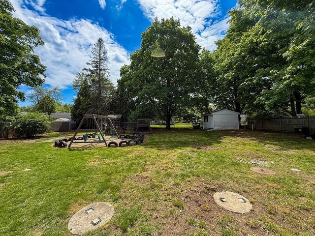 78 Howland Rd, Stoughton, MA 02072 - view of yard with a playground, a storage unit, and an outbuilding