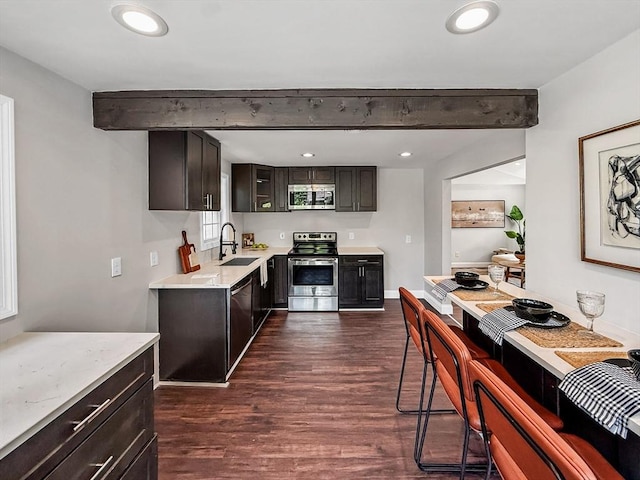 78 Howland Rd, Stoughton, MA 02072 - kitchen featuring stainless steel appliances, dark wood-style flooring, light countertops, a sink, and beamed ceiling