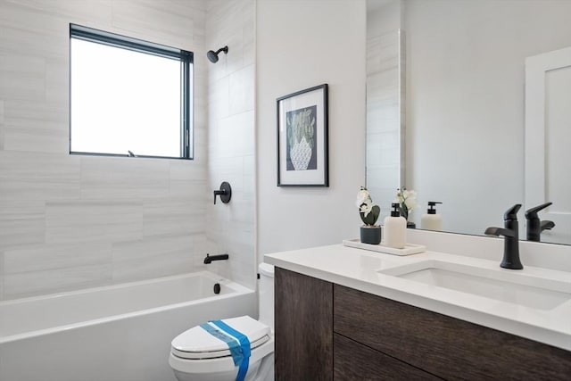 full bathroom featuring toilet, tiled shower / bath combo, and vanity