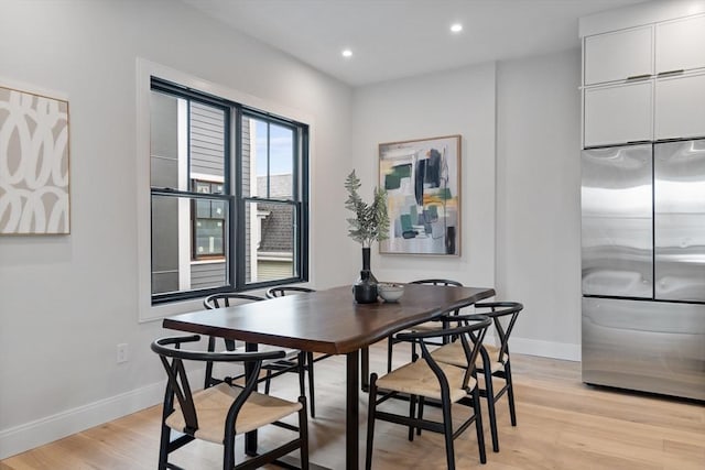 dining space with light hardwood / wood-style floors