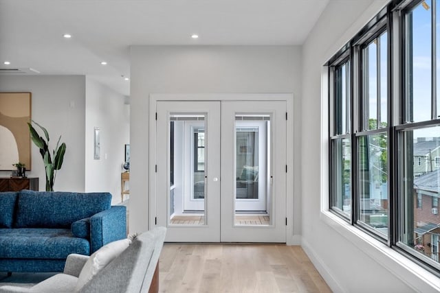 doorway to outside featuring light hardwood / wood-style flooring and french doors