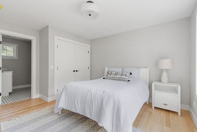 bedroom featuring light hardwood / wood-style floors and a closet