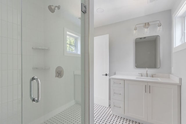 bathroom featuring vanity and a shower with shower door