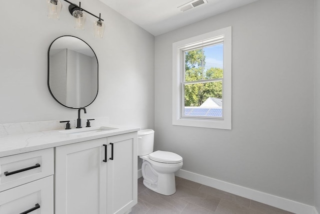 bathroom featuring tile patterned flooring, vanity, and toilet