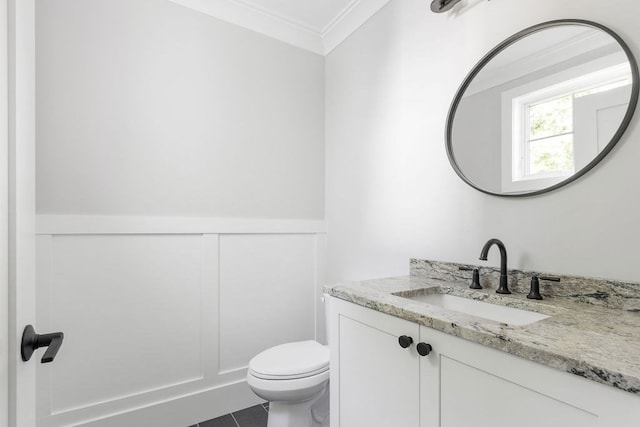 bathroom featuring ornamental molding, vanity, toilet, and tile patterned floors