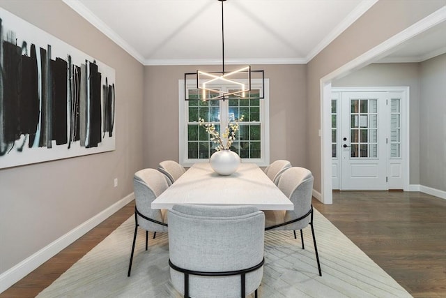 dining area with a chandelier, wood finished floors, baseboards, and ornamental molding