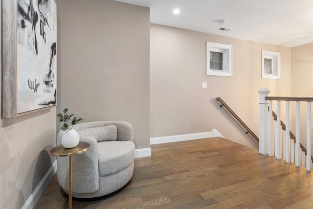 living area featuring an upstairs landing, baseboards, wood finished floors, and recessed lighting